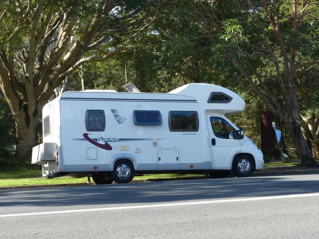 Motorhome and motorcycles parked at a scenic campsite near Vienna