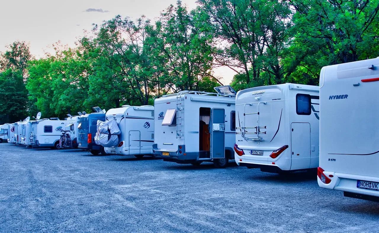 Motorhome and motorcycles parked at a scenic campsite