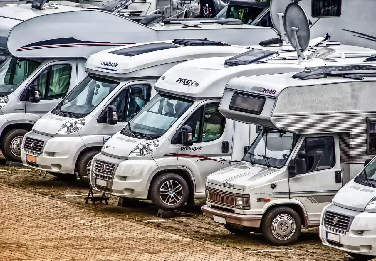 Motorradgruppe und Wohnmobile auf einem Campingplatz
