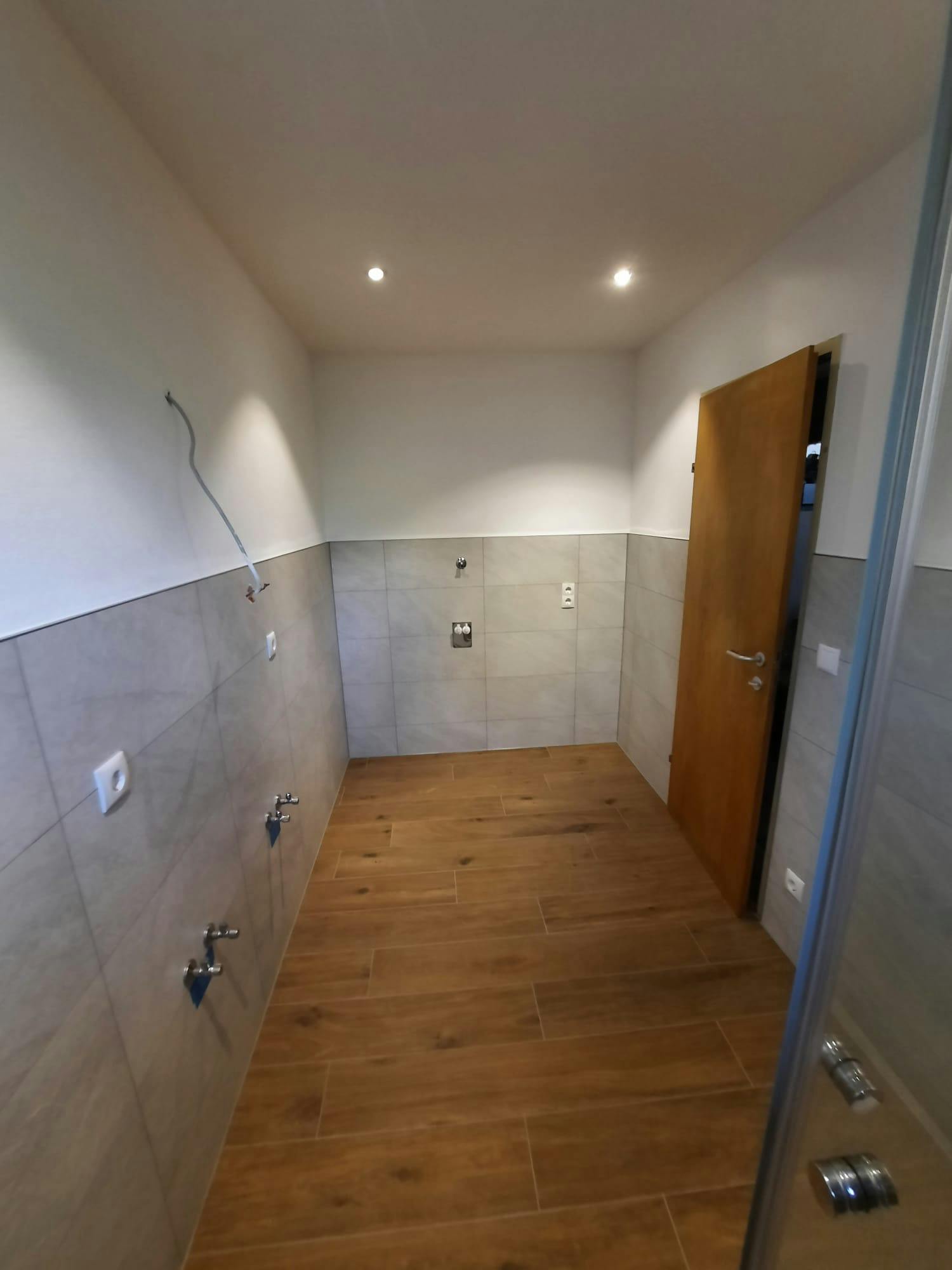Modernes Badezimmer mit eleganter Duschkabine und hochwertigen Keramikfliesen